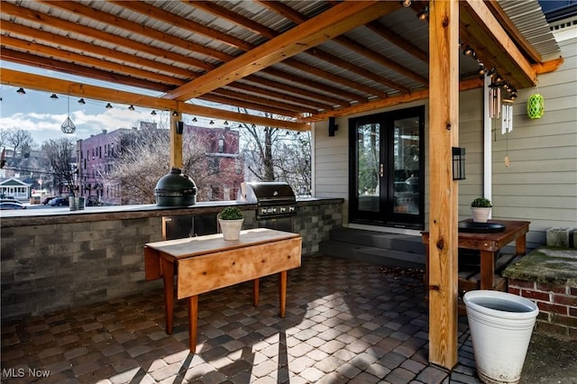 view of patio / terrace featuring exterior kitchen, grilling area, and french doors