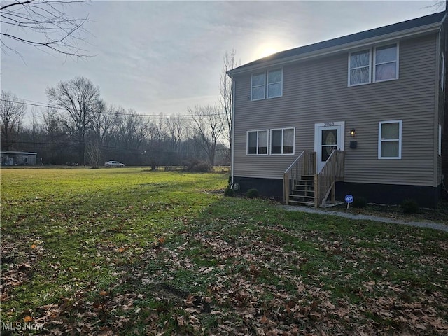 rear view of property with a lawn