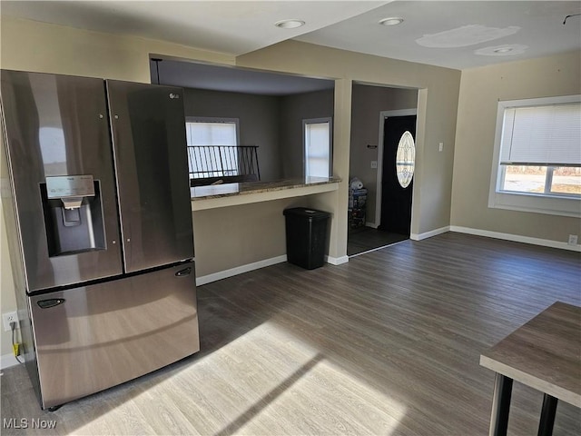 kitchen with dark wood-type flooring and stainless steel refrigerator with ice dispenser