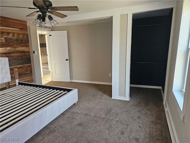 unfurnished bedroom featuring carpet flooring, ceiling fan, and a closet