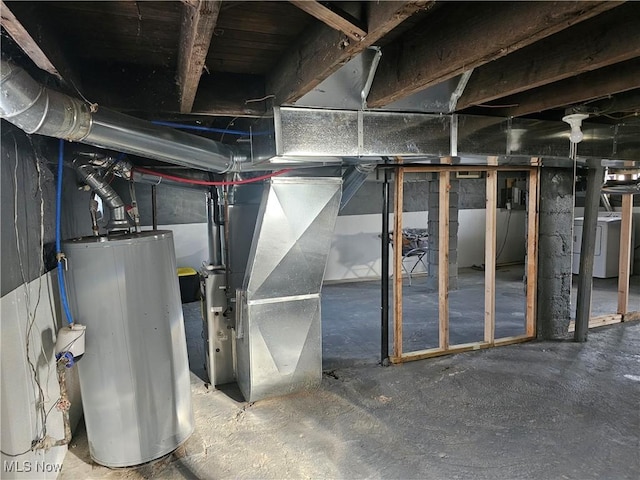 basement featuring heating unit, washer / dryer, and water heater