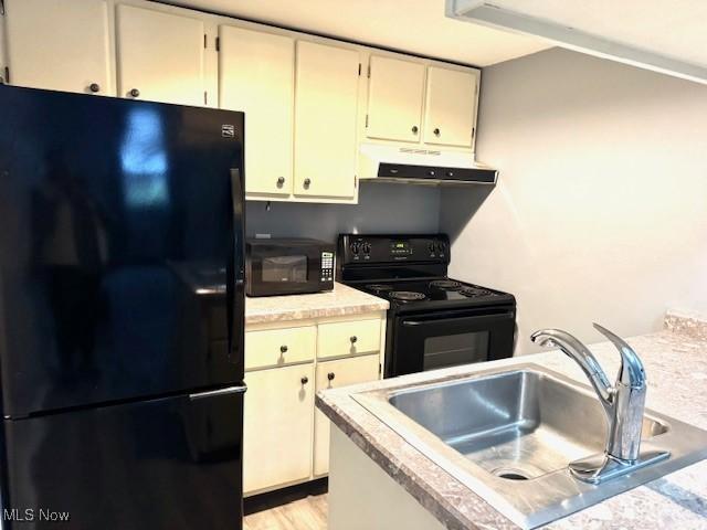 kitchen featuring sink and black appliances