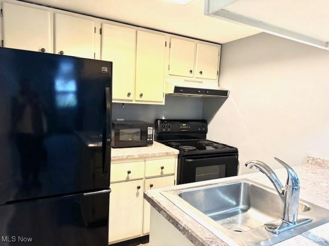 kitchen featuring black appliances and sink