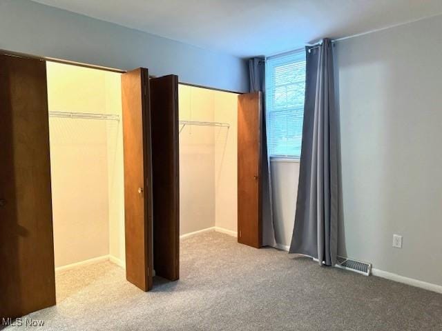 unfurnished bedroom featuring carpet and a closet