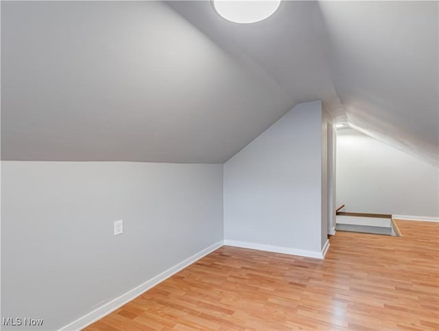 bonus room featuring light hardwood / wood-style floors and vaulted ceiling