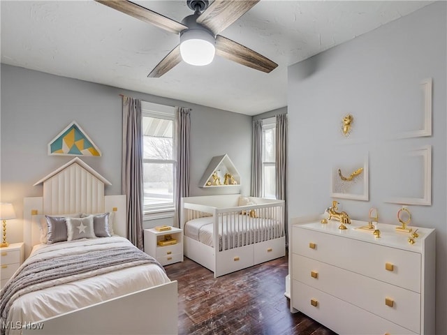 bedroom featuring ceiling fan and dark wood-type flooring