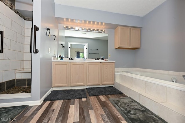 bathroom featuring hardwood / wood-style floors, vanity, and independent shower and bath