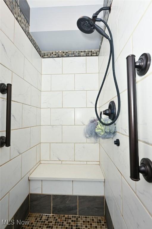 bathroom with tiled shower