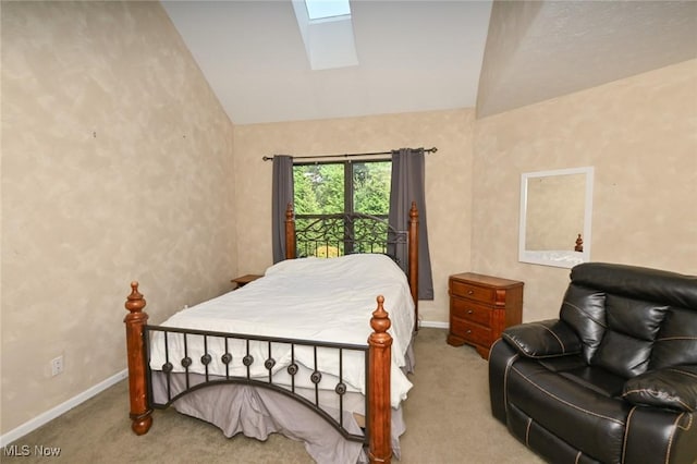 carpeted bedroom with lofted ceiling with skylight