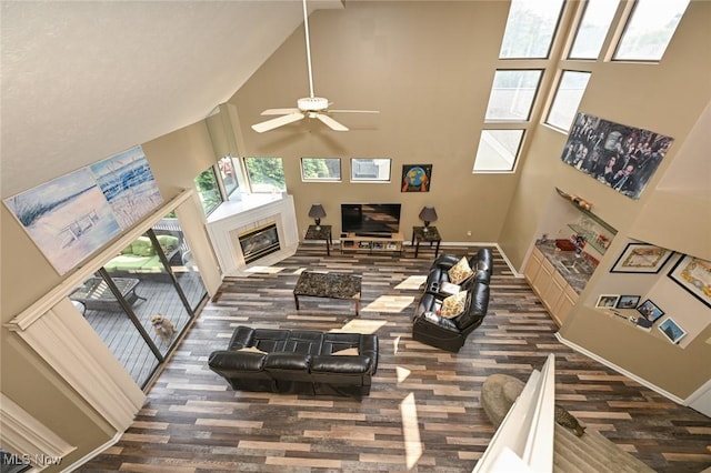 living room with ceiling fan and a high ceiling