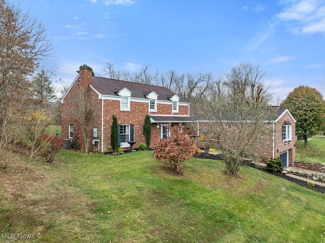 view of front facade featuring brick siding, a chimney, central AC unit, a garage, and a front lawn