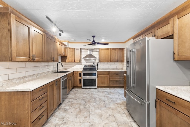 kitchen with backsplash, wall chimney range hood, sink, ornamental molding, and stainless steel appliances