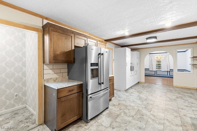 kitchen with stainless steel fridge and backsplash