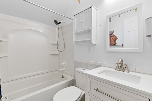 full bath with toilet, bathing tub / shower combination, vanity, and tile walls