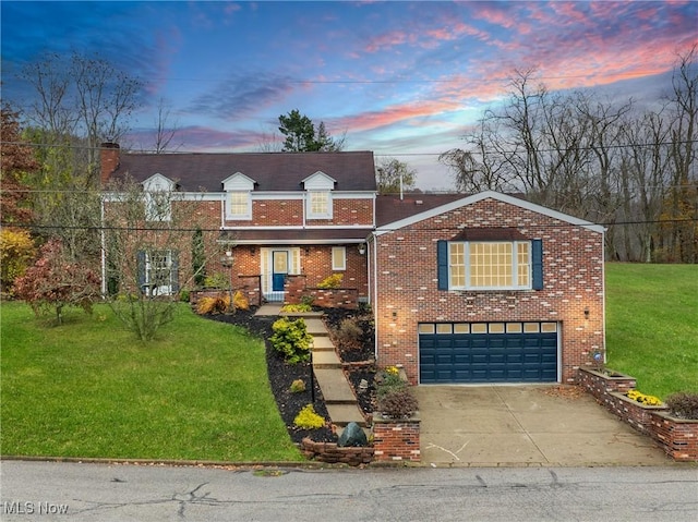 traditional-style house with concrete driveway, brick siding, a yard, and an attached garage