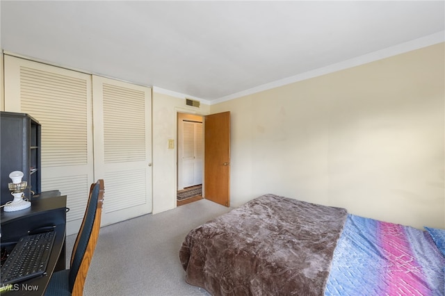 carpeted bedroom with crown molding and a closet