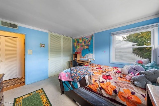 bedroom with light carpet, a closet, and ornamental molding