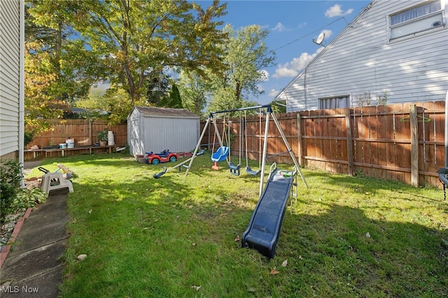 view of yard featuring a playground and a storage shed