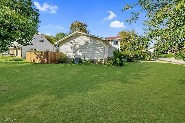 view of side of home featuring a yard