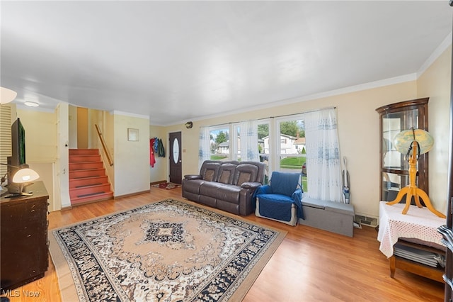 living room featuring hardwood / wood-style floors and ornamental molding