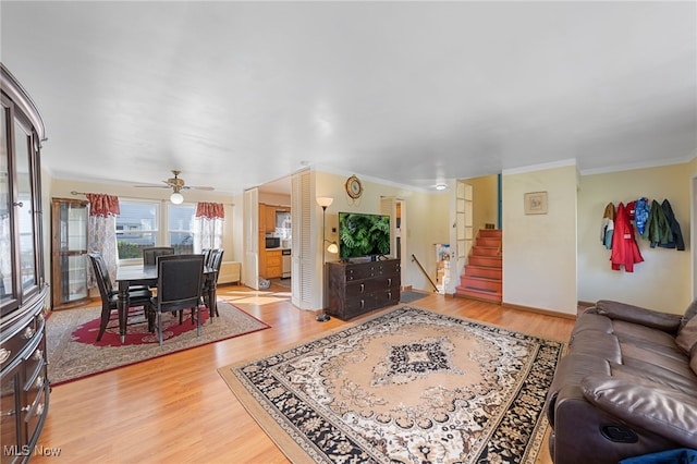 living room featuring ceiling fan, crown molding, and hardwood / wood-style flooring