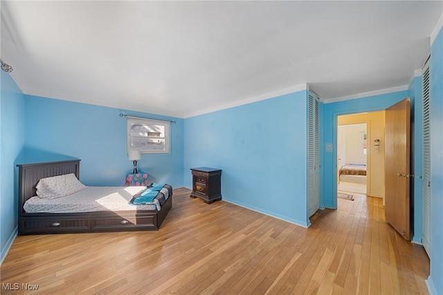 bedroom featuring light hardwood / wood-style floors and ornamental molding