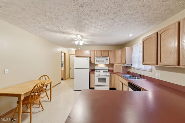 kitchen featuring a textured ceiling, light brown cabinetry, sink, and white appliances