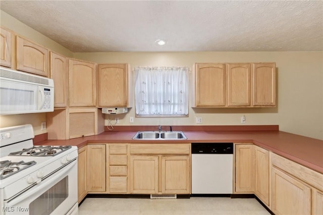 kitchen featuring a textured ceiling, sink, white appliances, and light brown cabinets