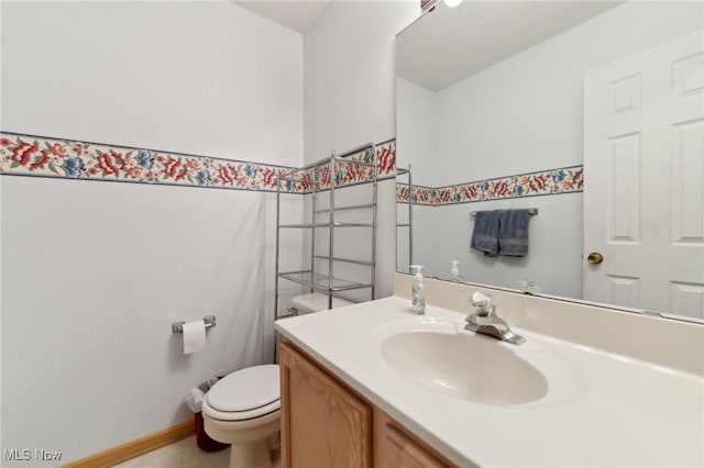 bathroom featuring vanity and toilet