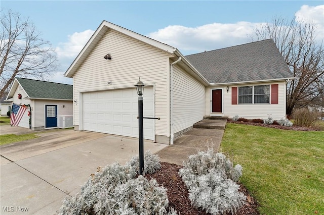 view of front of property with a front yard and a garage