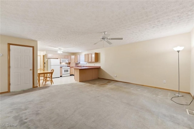 unfurnished living room featuring ceiling fan, light colored carpet, and a textured ceiling