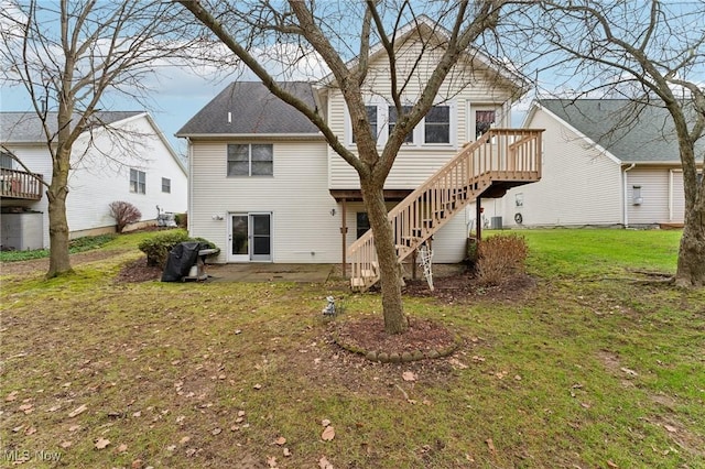 back of property featuring a yard and a deck