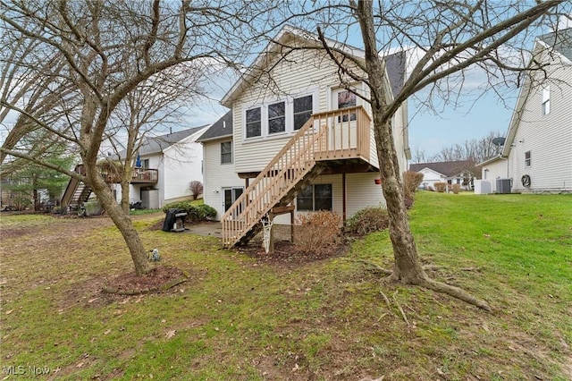 back of house featuring a lawn and central AC