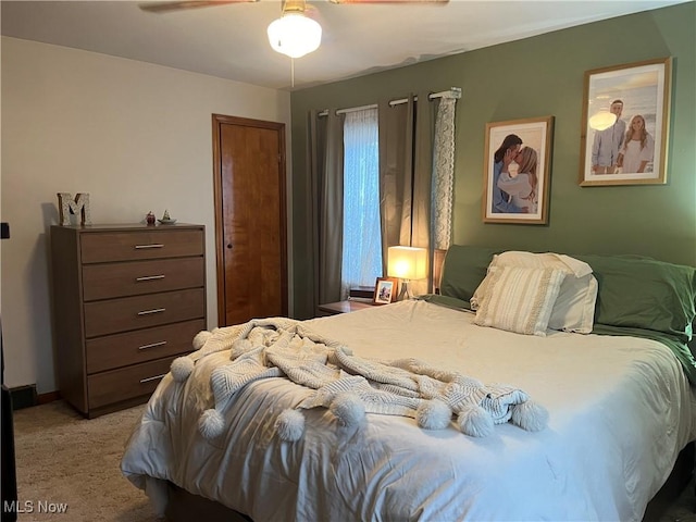 bedroom with ceiling fan and light colored carpet