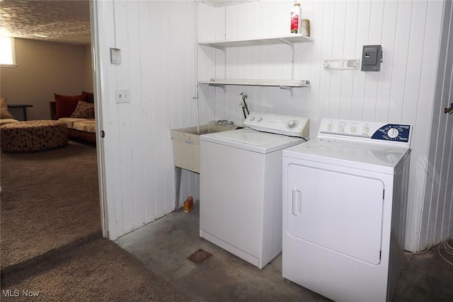 washroom with dark colored carpet, wood walls, and washing machine and clothes dryer