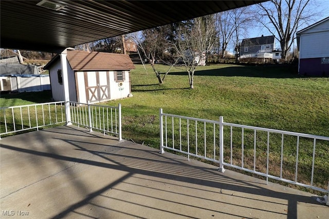 wooden deck featuring a shed and a yard