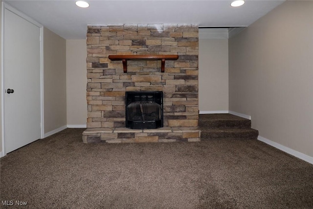 unfurnished living room with carpet flooring and a wood stove