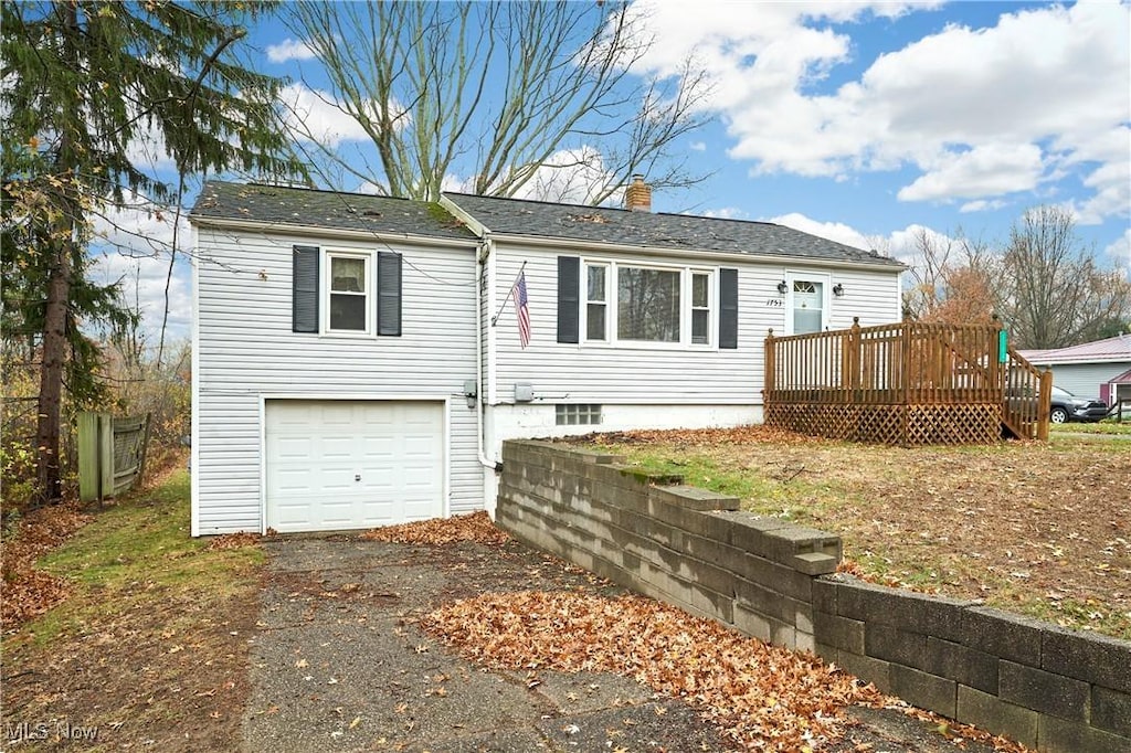 view of front facade featuring a garage and a wooden deck