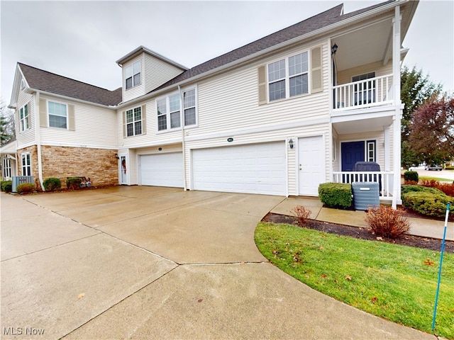 view of front of home featuring central AC unit and a garage