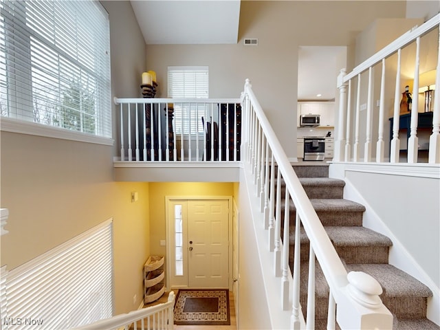 staircase with a high ceiling