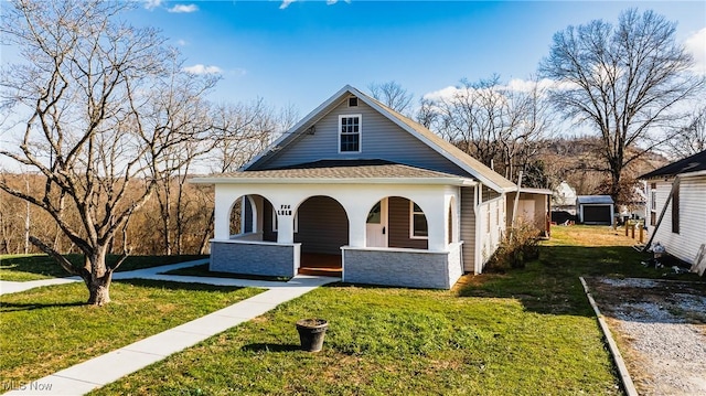 view of front of home featuring covered porch and a front lawn