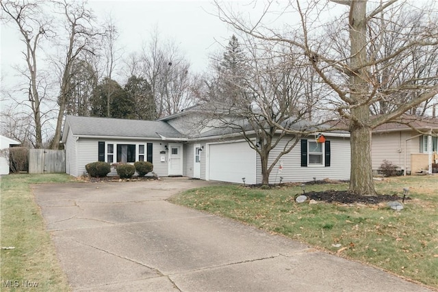 view of front of house with a front yard and a garage