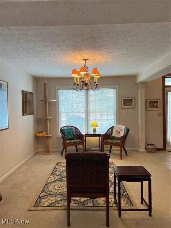 carpeted dining room featuring a textured ceiling and a chandelier