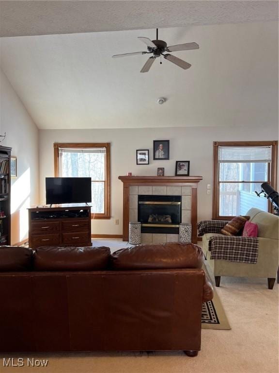 living room featuring a fireplace, carpet, ceiling fan, and lofted ceiling