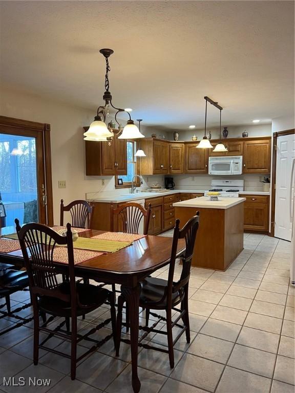 dining space with sink and light tile patterned floors