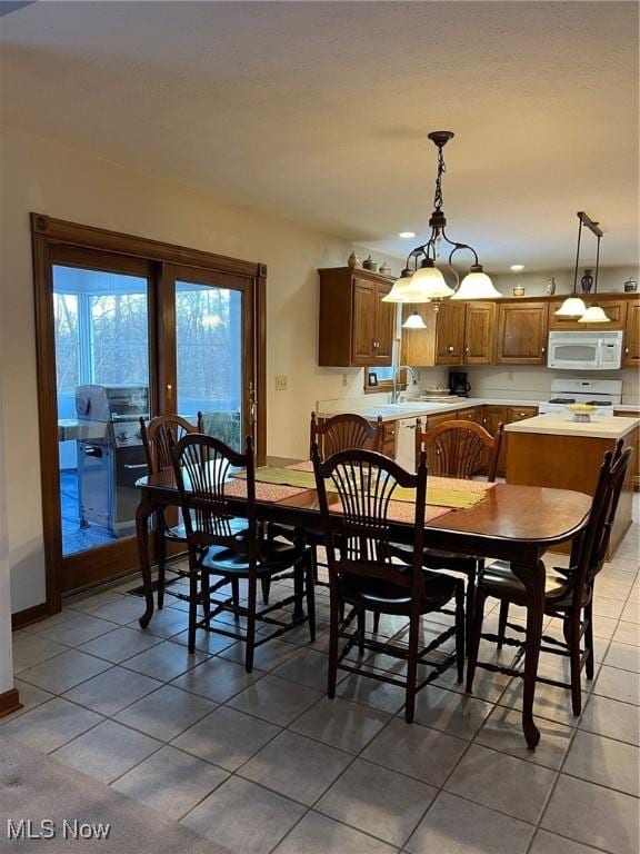 tiled dining space featuring sink