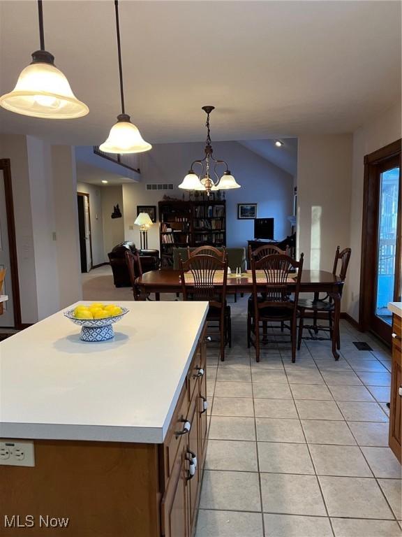 kitchen featuring decorative light fixtures, a center island, and light tile patterned flooring