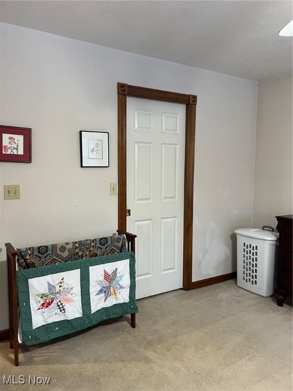 bedroom featuring light carpet