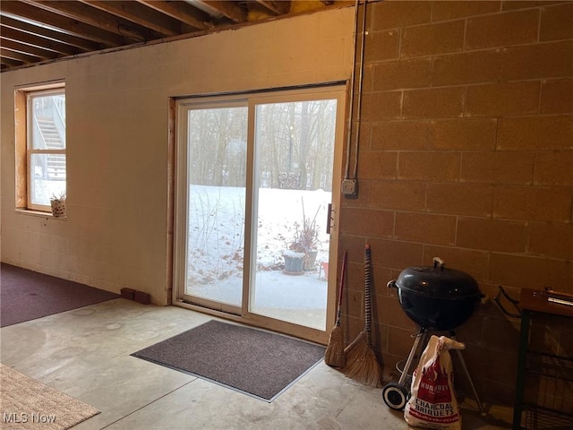 doorway to outside with concrete floors