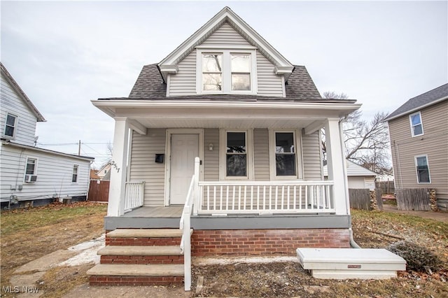 bungalow-style house with a porch and cooling unit